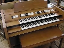 When a spinet organ with two split manuals and 13 stub pedals proves too small finally [See blog, The Spinet Organ] and the playing of the novice organist develops into a more serious study, and not having enough keys, pedals, and stops are holding back progress, it becomes necessary to think about a step up instrument for home practice.
A small pipe organ would be the ideal practice instrument, but many families typically cannot supply the necessary funds or physical space to install this type of instrument in their residences.
It becomes then a search for the best electronic instrument that the available space and funds can accommodate.
It's probably a fair statement to say that during the analog electronic organ days of the 1960's the Conn Company was leading the field in the low price range of home organs, although other companies such as Lowery, Wurlitzer, Thomas, Baldwin, Gulbransen, and Allen also were producing some fine and entirely satisfactory instruments for the home.
The Conn Rhapsody Model 625 (photo) for example, which back in 1964 sold for under $2K, came equipped with two full size (61-note) manuals, a 40-watt vacuum tube amplifier, self-contained loudspeakers, and a 25 note flat, radiating pedalboard.
Like all Conn organs of that time, this instrument incorporated independent tone generation for each note and all 4 families of organ tone ... diapasons, strings, flutes, reeds ... in its stop list.
This model also came with sub and super couplers on the Solo manual and a little broader range of voices with better tone quality than most spinet organs of the day, although it was, for all practical purposes, a Conn Minuet 460 spinet organ in terms of voices but playable from a larger cabinet having more keys and pedals.
Instruments of this size and description have their place as the first step up instrument from the spinet level for continuing one's journey in organ playing.
(con't in Part II)