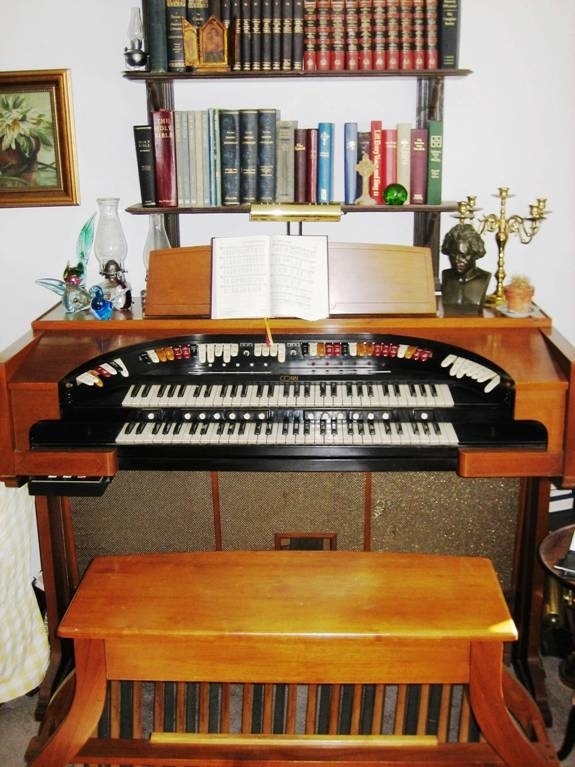 (con't from Part II)
Based upon the initial success of the model 640 theatre organ in 1962, the Conn company came out in 1964 with the model 645 deluxe theatre organ (photo).
The 645, like the 640, was also a vacuum tube oscillator organ, which gave it a full sound that was very solid.
The 645 achieved some advances over the 640, starting with the elimination of the 640's sub and super couplers on the Solo manual which were replaced with independent 16-foot and 4-foot stops in the Solo which could be combined in new and different ways.
Another advance was the replacement of the 640's 25 note pedalboard with a full size 32-note AGO pedalboard.
The 645 also came with some new, additional voices, such as a 16-foot pedal reed marked 
