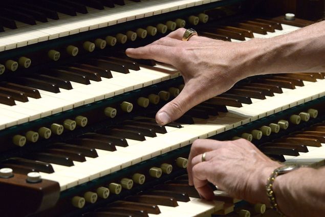 Organists who play on instruments of 3 or more manuals are free to employ the technique of thumbing down, this to be able to play 2 separate melodic lines of different tone color with the right hand across manuals, simultaneously (photo).
This technique developed in France during the 19th century, notably in the organ compositions of Alexandre Guilmant, Charles-Marie Widor, and others, although Guilmant is usually given credit for originating it.
This is done by first drawing single stops of contrasting tone colors, e.g., flute and reed, on adjacent manuals, holding a note with the thumb on the lower of the 2 manuals, such as the Great, and allowing the remaining four fingers to move on the manual immediately above it (the Swell, in this case).
The process can also be reversed, i.e., the held note can be on the manual above with the moving notes taken by the thumb below.
When such passages are written out, the score for the right hand part will show 2 staves; the part for the fingers will be marked on the highest staff, and the thumb notes will be marked on the staff right under it.
This technique is demonstrated in the closing of 