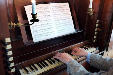 The pipe organ's pedals don't always have to be employed to have a pervading bass or big sound.
The left hand low on the main manual with proper stops and couplers drawn, even on a single manual pipe organ (photo), can supply that need [See menu bar, Video].