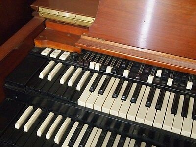(con't from Part I)
History has shown that the Hammond B-3 (photo) console organ was the most popular and most widely used among the older Hammond models.
In this photo the bottom octave preset keys are visible in reversed colors on both the Swell (upper) and Great (lower) manuals; these have a locking spring action when depressed to indicate that they are engaged; they may be released, or cancelled, at any time by depressing the (black) low C preset key.
Closer examination reveals that both the A# and B preset keys on the Swell manual have been depressed two-at-a-time, allowing both banks of Swell harmonic drawbars visible above the top manual to sound together.
(con't in Part III)
