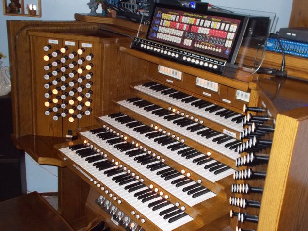 (con't from Part II)
The Duet virtual theatre pipe organ (VTPO) unit manufactured by MIDI Concepts LLC (photo) during the 1990's and early 2000's required only one or more MIDIfied keyboards and a speaker system for playability; a host console's manuals and speaker system could also be employed for this purpose, provided that it was able to send MIDI information to Duet.
Duet consisted of 1) a sound generator box, 2) a memory stick (USB thumb drive) which stored all of its voices, couplers, controls, and MIDI-configuration for the host instrument, and 3) a touch-sensitive control panel provided with 2-phase LED lighting.
These three components communicated with the host instrument via a MIDI cable and with the external speaker system by means of an audio cable.
Production of this VTPO was limited -- only about 200 made it into circulation -- and very few remain in working condition, but if and when organists may encounter one they will find themselves in for a treat.
This was a serious piece of equipment which could be used with any MIDIfied host instrument including electronic organs, pipe organs, or keyboard rack systems -- a complete III/24 unit theatre organ which offers ranks sampled from Wurtlizer, Barton, Kimball, and Page theatre organs, 208 possible stops, and Great and Accompaniment Double Touch stops for those manuals supplied with this feature.
Its memory stick also could be configured for any MIDI-capable digital piano without pedals (in which case the Accompaniment and Pedal voices would play below the split point and either the Great or Solo voices would play above the split point depending upon the position of the Solo/Great (S/G) flip switch on the lighted control panel.
Adding or subtracting a single stop, coupler, modifier, or changing the memory level with this unit could be done 
